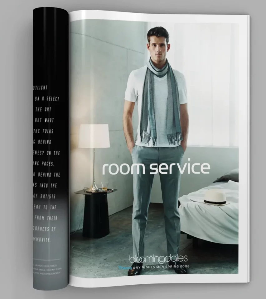 A male model wearing a Theory white t-shirt and scarf in a hotel room setting. Campaign by PlanetFab Studio